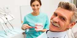 Smiling man with dentures at the dentist