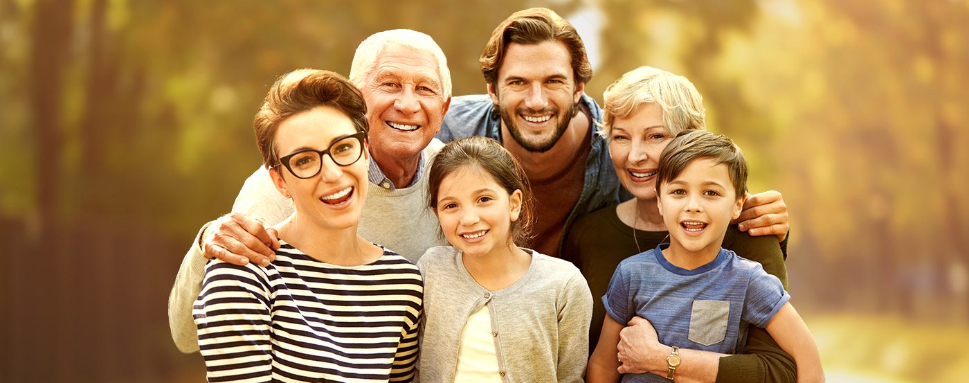 Smiling family of grandparents parents and children