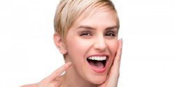 A woman pointing at her smile.