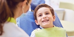 Boy smiling in dental chair