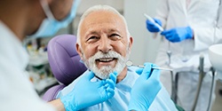 A senior man who’s just received his new dentures