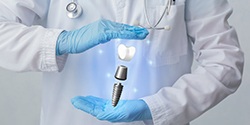 implant dentist in Denton with a hologram of a dental implant in their hands 