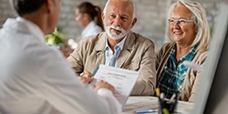 senior man and woman at a consultation for implant dentures 