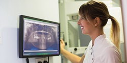 dental team members looking at a patient’s X-rays