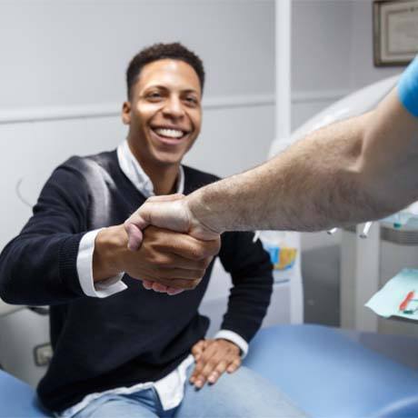 Patient shaking dentist's hand