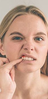 Woman pointing at tooth