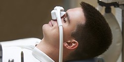 man wearing nasal mask in dental chair 