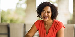 Woman smiling while sitting outside