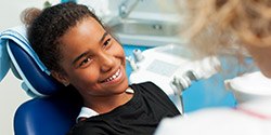 Smiling young girl in dental chair