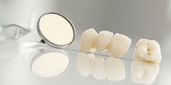 Dental mirror and teeth lying on table