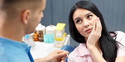 Woman visiting the dentist about tooth pain