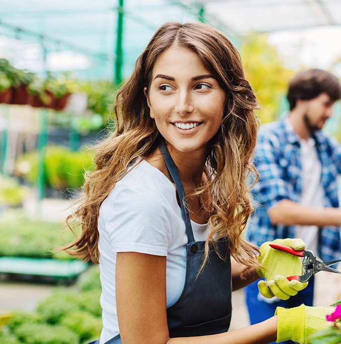 Lady smiling while gardening