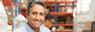 Smiling man in warehouse