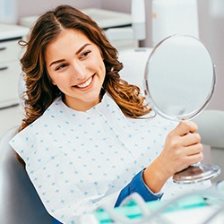 Woman looking at smile in mirror