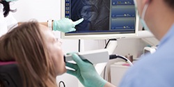 Woman and dentist looking at intraoral photos