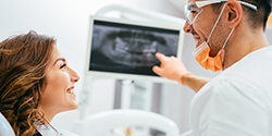 Woman and dentist looking at digital x-rays