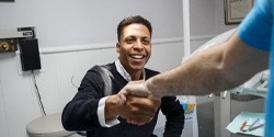 Man shaking dentist’s hand after teeth whitening in Denton, TX
