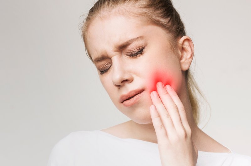 woman with sensitive teeth dental emergency in Denton