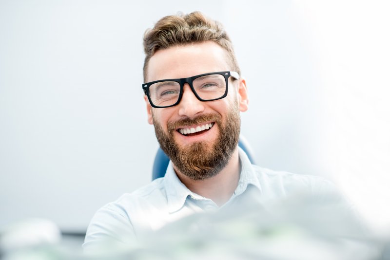 Handsome businessman with great smile sitting in the dental chair