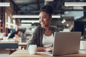 woman drinking coffee at work