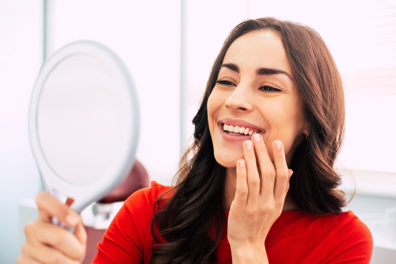 A woman smiling with her new dental veneers