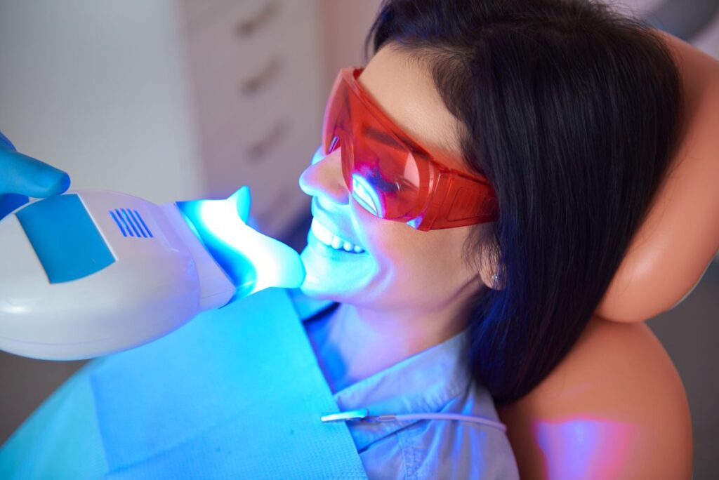 A woman getting professional teeth whitening treatment