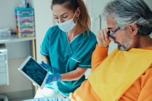  Dentist reviewing X-ray with patient 