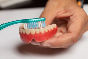 Person brushing their dentures