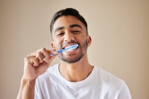 Man brushing his teeth. 